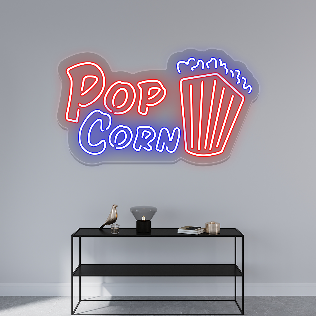 Red and blue popcorn bucket LED neon sign above a console table