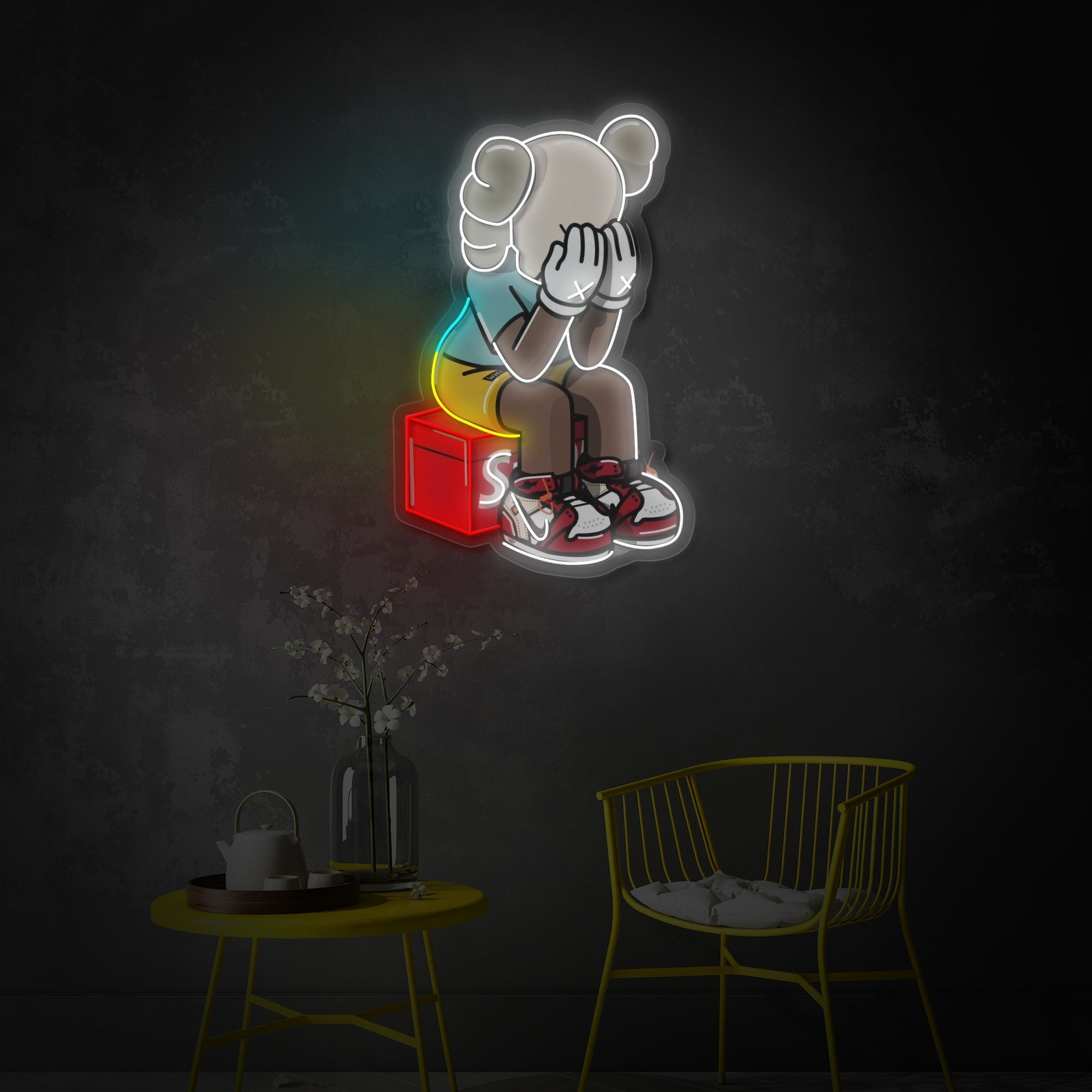 An LED neon sign featuring a stylized, cartoon-like seated figure with a colorful backdrop, mounted on a wall.