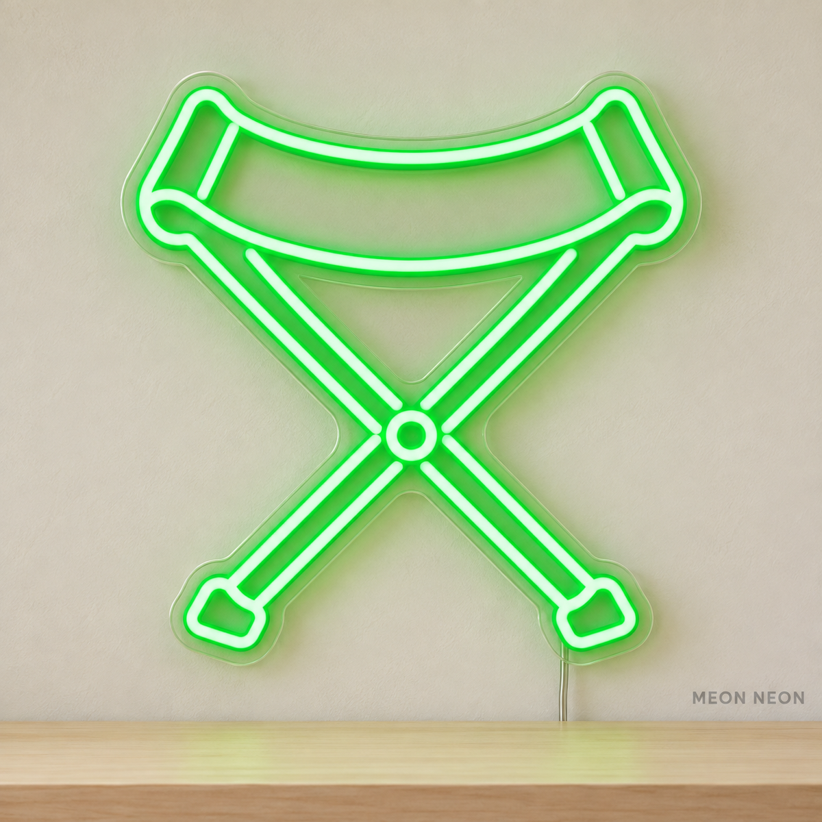 Watermarked concept mockup of Mini Camp Stool LED Neon Sign in Green on a clear acrylic backboard.