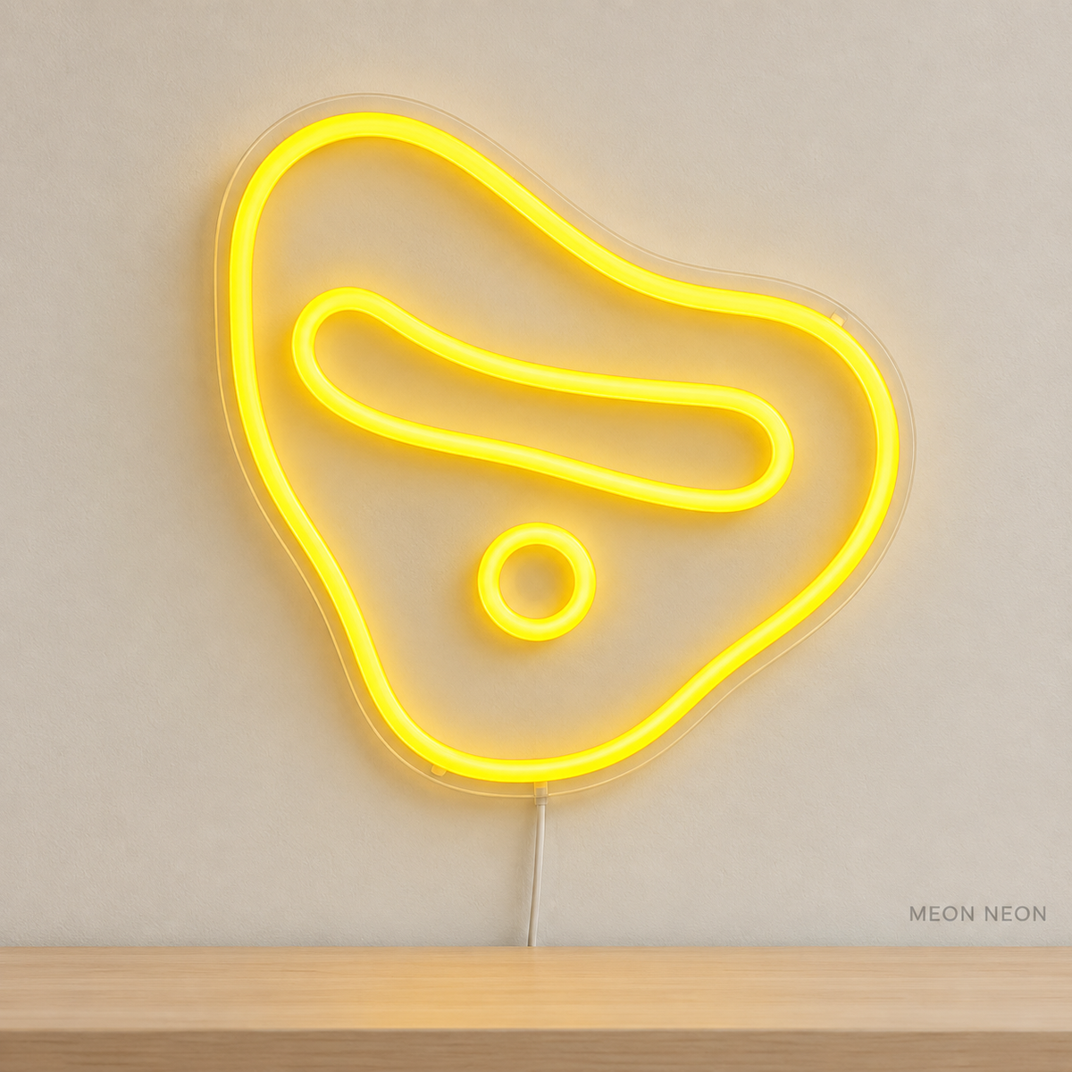 Watermarked concept mockup of Mini Climbing Hold LED Neon Sign in Yellow on a clear acrylic backboard.