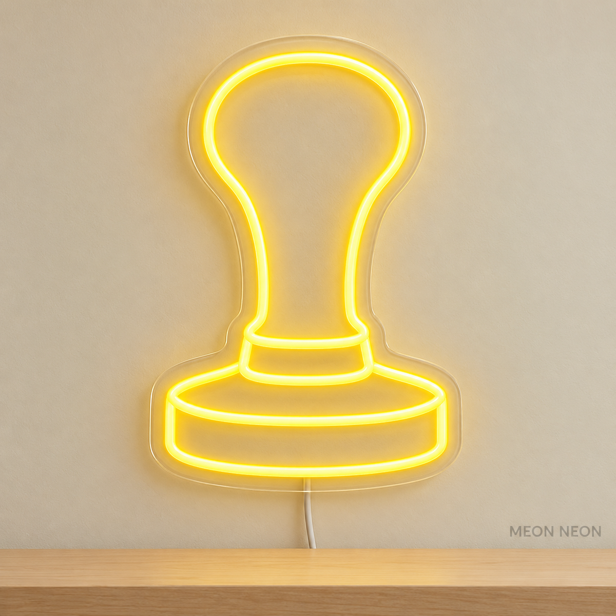 Watermarked concept mockup of Mini Coffee Tamper LED Neon Sign in Yellow on a clear acrylic backboard.