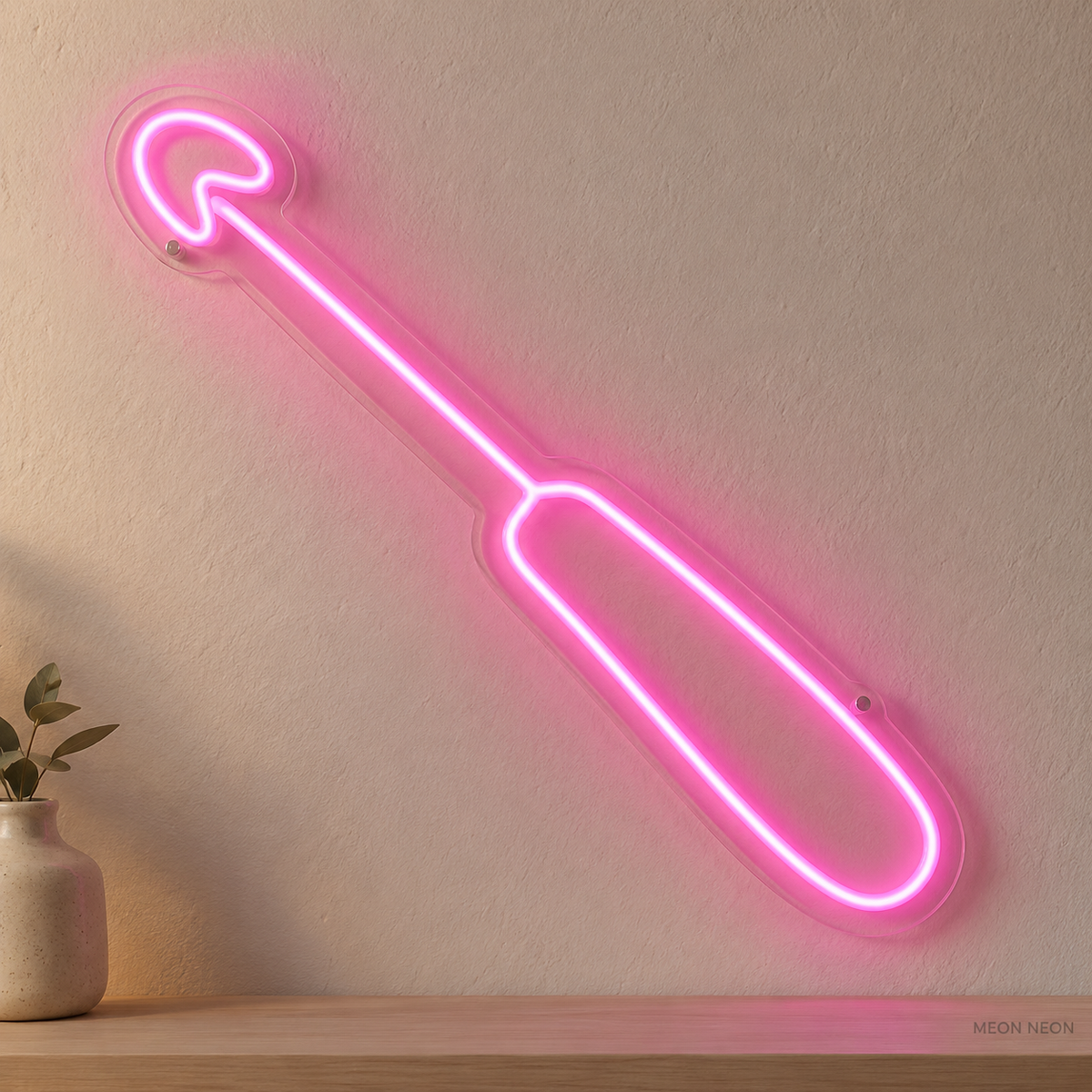 Watermarked concept mockup of Mini Crochet Hook LED Neon Sign in Pink on a clear acrylic backboard.