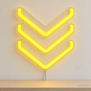 Watermarked concept mockup of Mini Deco Chevron LED Neon Sign in Yellow on a clear acrylic backboard.