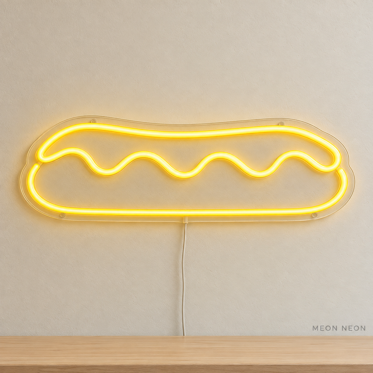 Watermarked concept mockup of Mini Eclair LED Neon Sign in Yellow on a clear acrylic backboard.