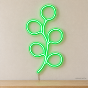 Watermarked concept mockup of Mini Eucalyptus Stem LED Neon Sign in Green on a clear acrylic backboard.