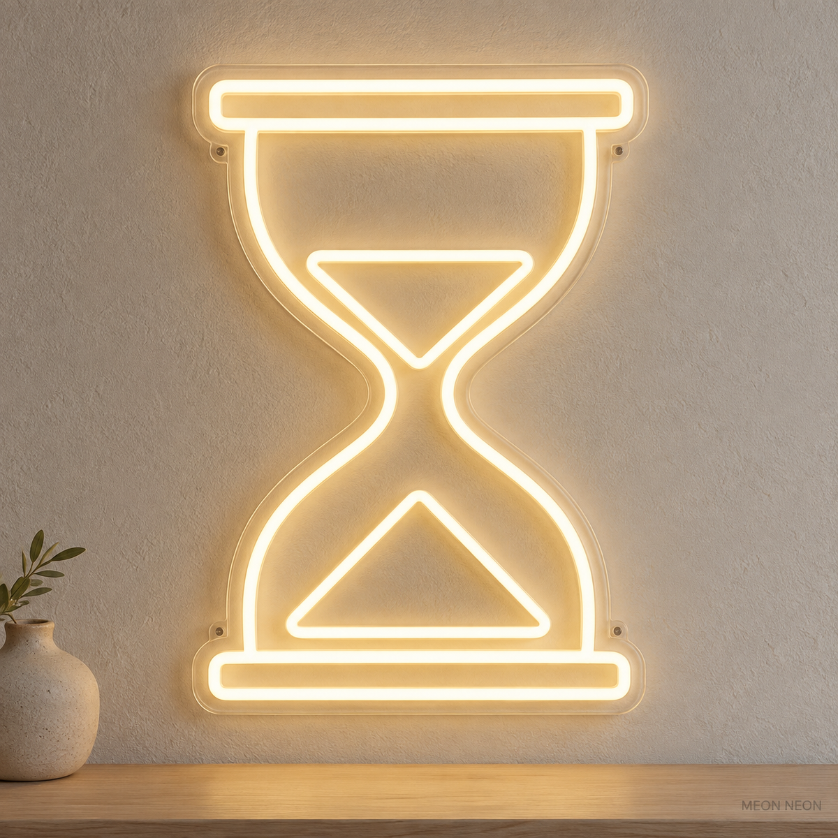 Watermarked concept mockup of Mini Hourglass LED Neon Sign in Warm White on a clear acrylic backboard.