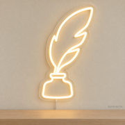 Watermarked concept mockup of Mini Quill and Ink LED Neon Sign in Warm White on a clear acrylic backboard.