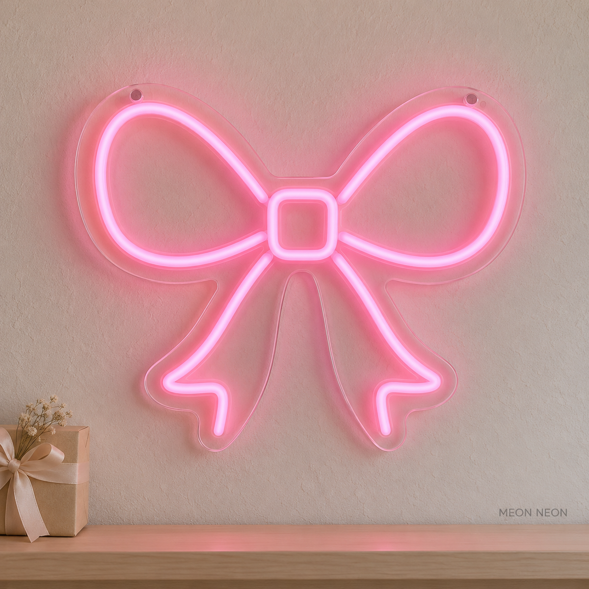 Watermarked concept mockup of the Mini Ribbon Bow LED Neon Sign in Pink on a clear acrylic backboard.
