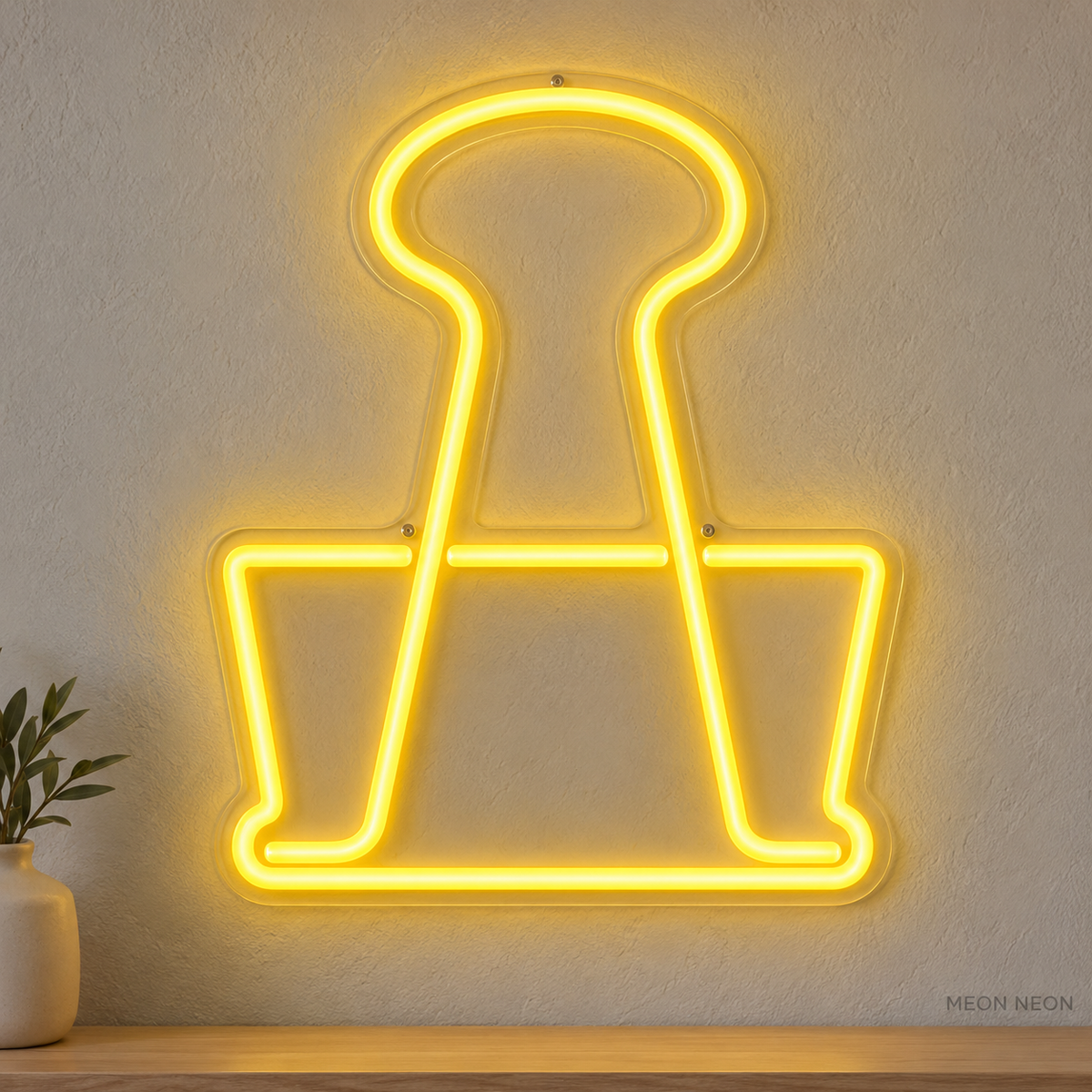 Watermarked concept mockup of Mini Stationery Clip LED Neon Sign in Yellow on a clear acrylic backboard.
