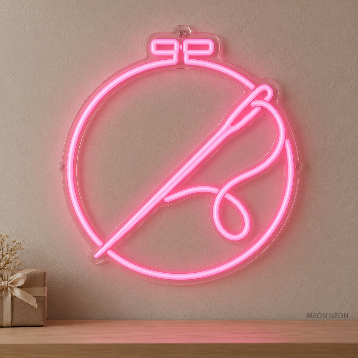 Watermarked concept mockup of the Mini Stitch Hoop LED Neon Sign in Pink on a clear acrylic backboard.
