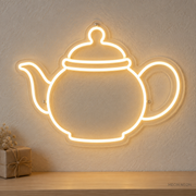 Watermarked concept mockup of the Mini Teapot LED Neon Sign in Warm White on a clear acrylic backboard.