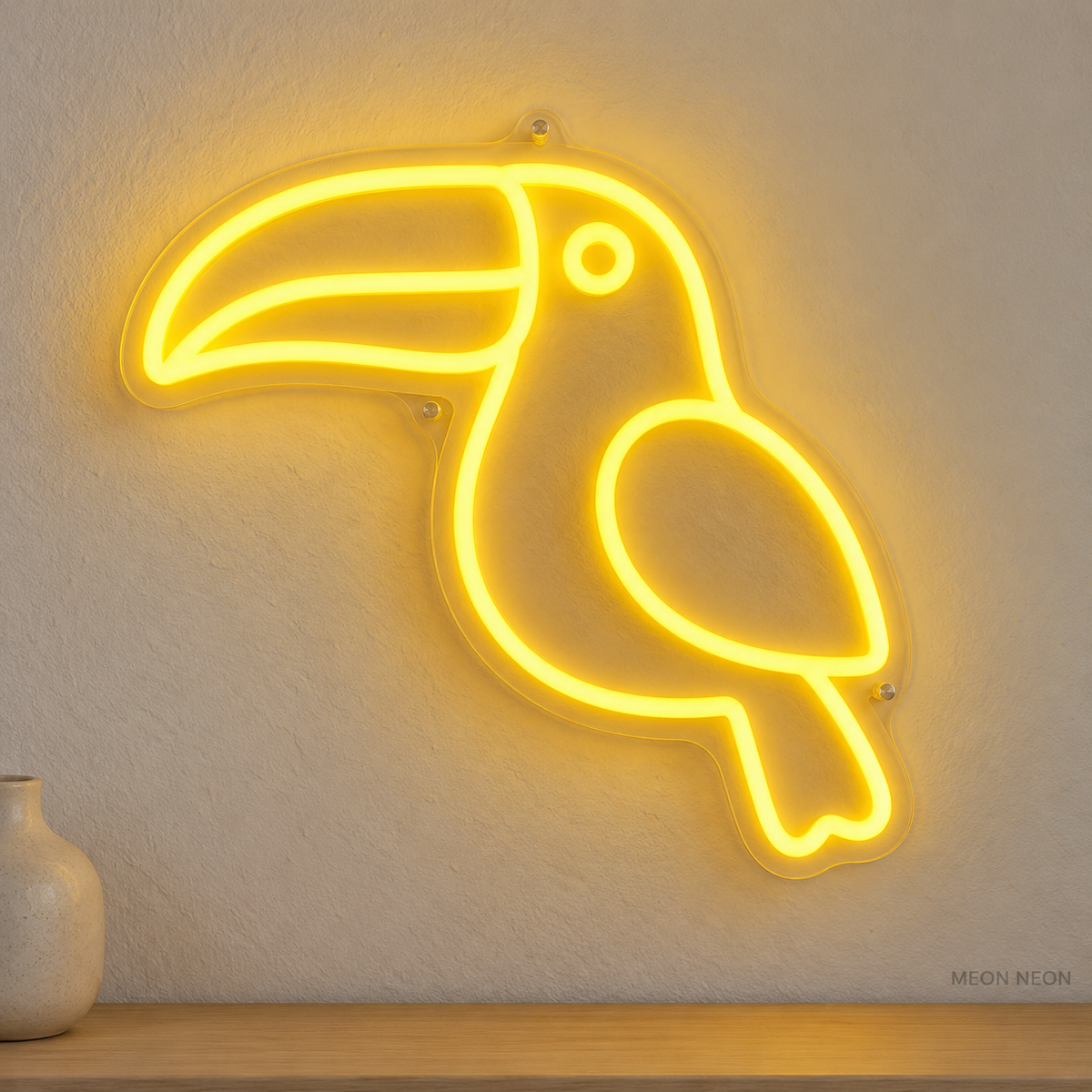 Watermarked concept mockup of Mini Toucan LED Neon Sign in Yellow on a clear acrylic backboard.