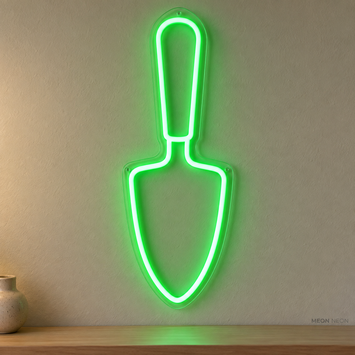 Watermarked concept mockup of Mini Trowel LED Neon Sign in Green on a clear acrylic backboard.