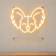 MEON NEON-watermarked concept mockup of a Warm White Papillon head LED neon sign with a blank acrylic area for a UV-printed breed caption or dog name.